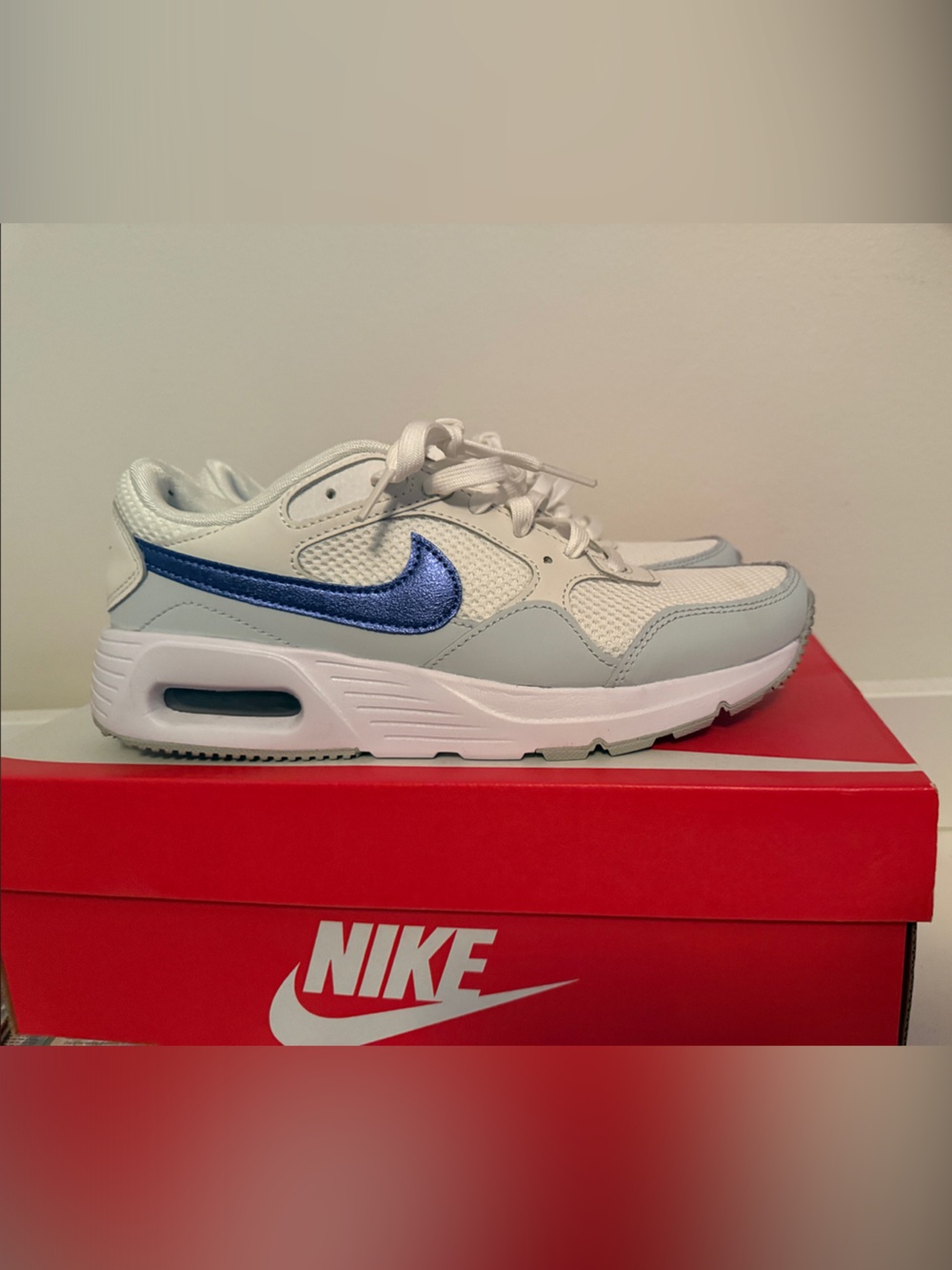 Nike Women's White Sneakers with Metallic Blue Swoosh